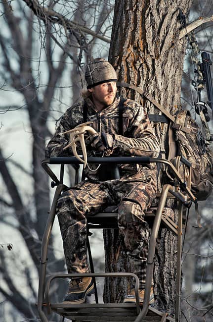 Parker sits in a tree stand, "calling in the big one" at the Dick's photo shoot.