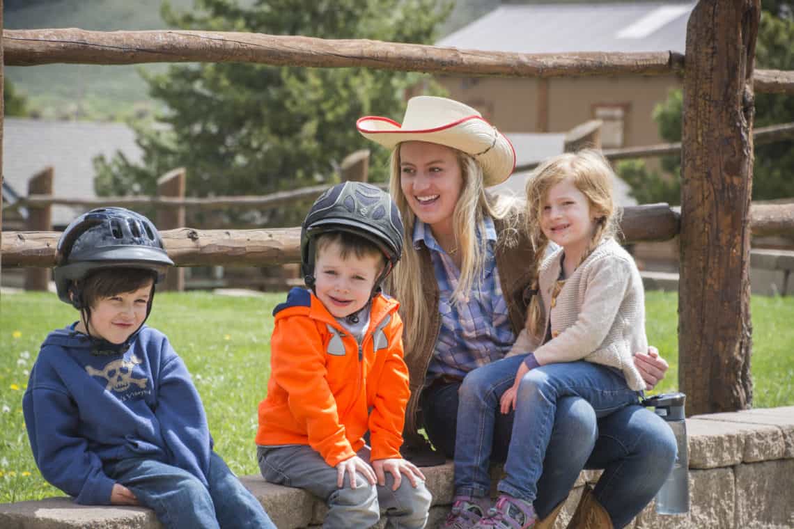 Woman sitting with three kids