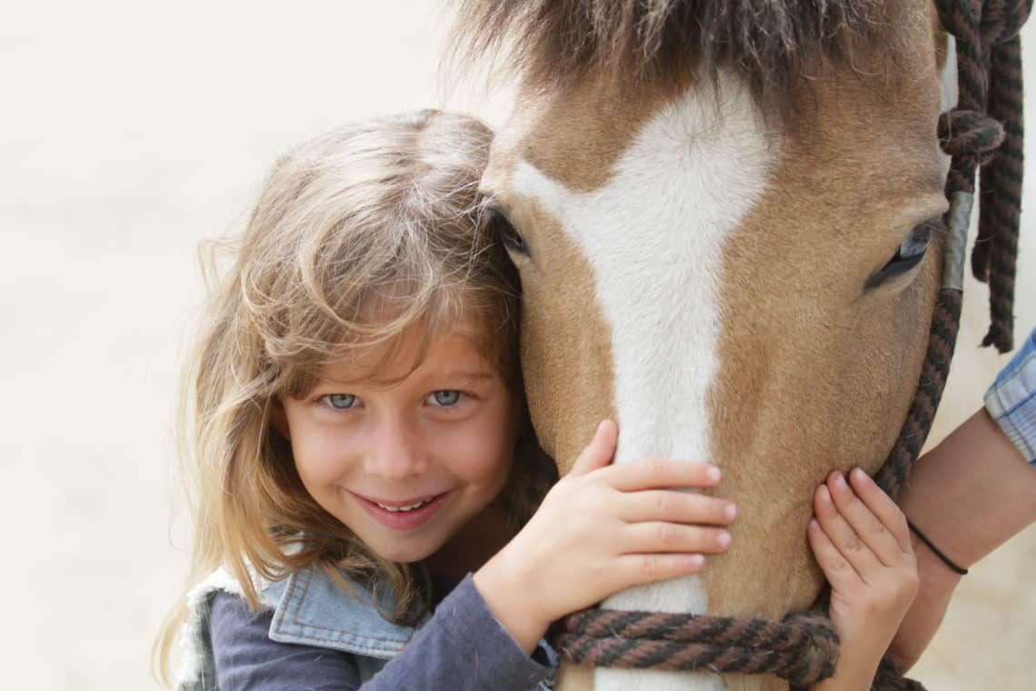 girl petting horse