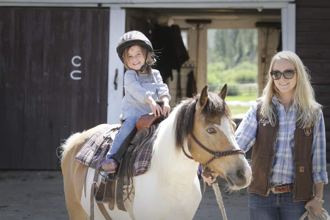 young girl riding pony