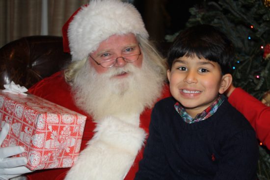 Santa and one of the many children on ranch pose for a picture