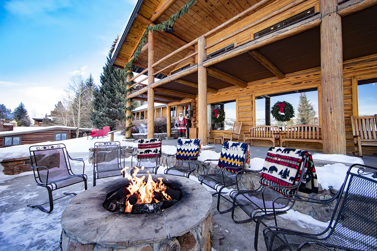 A warm fires burns outside the C Lazy U main lodge