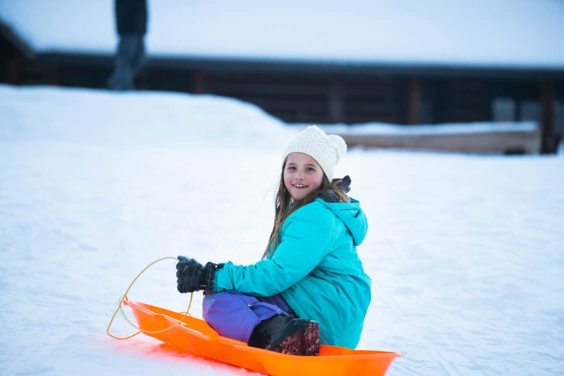 girl sitting on sled