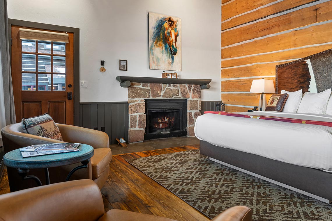 King bed, fireplace and sitting area in Roundup A2 on the upper floor