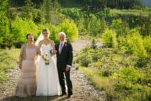 a bride posing with her parents at C Lazy U Ranch