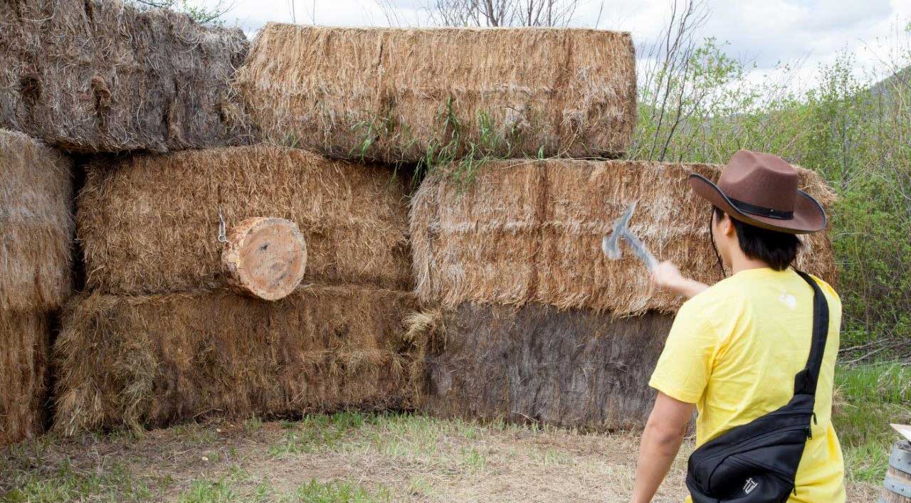 axe throwing at hay bails