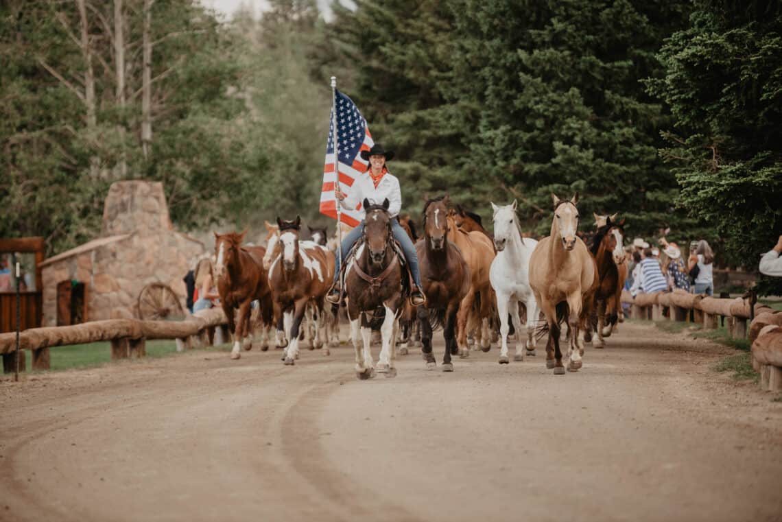 tami burkett with horses at colorado ranch