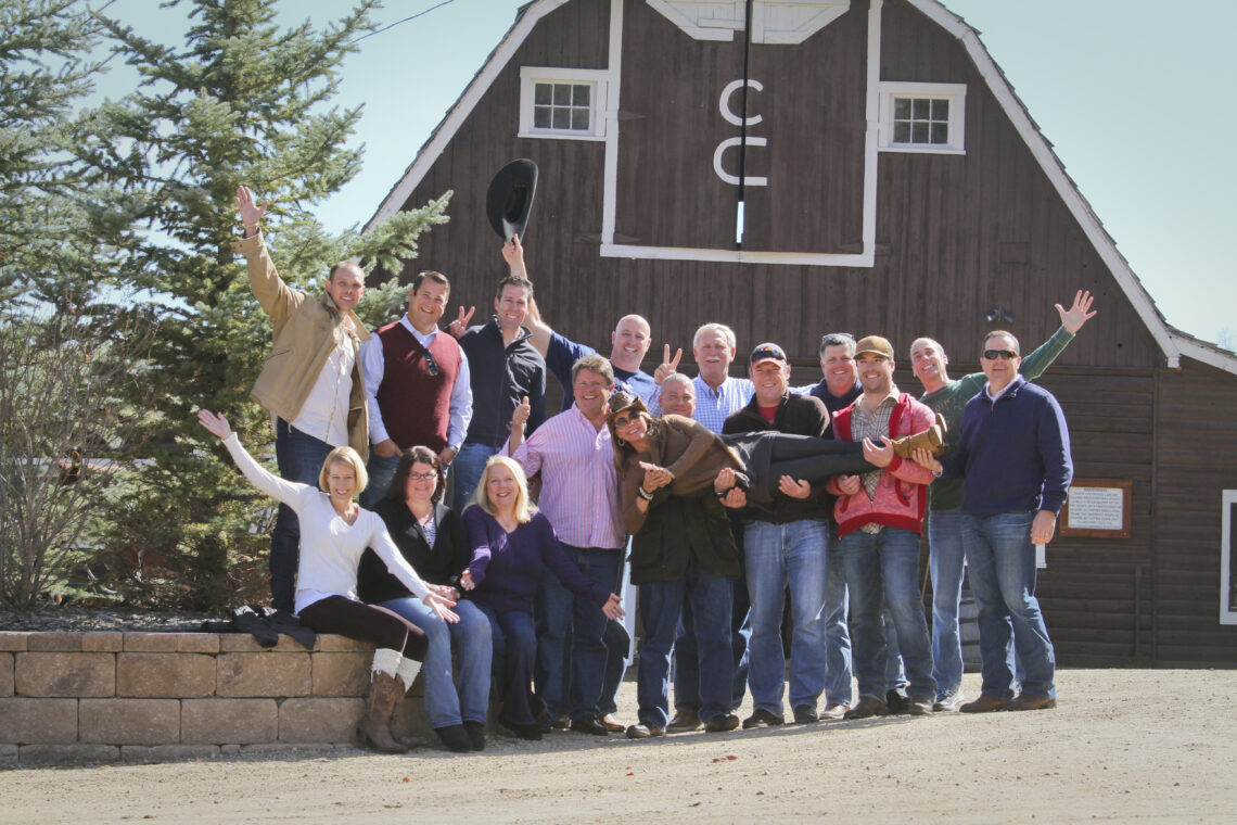 Guests of corporate retreat smile and pose for a group photo