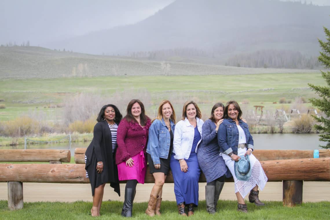 women poses in front of mountains