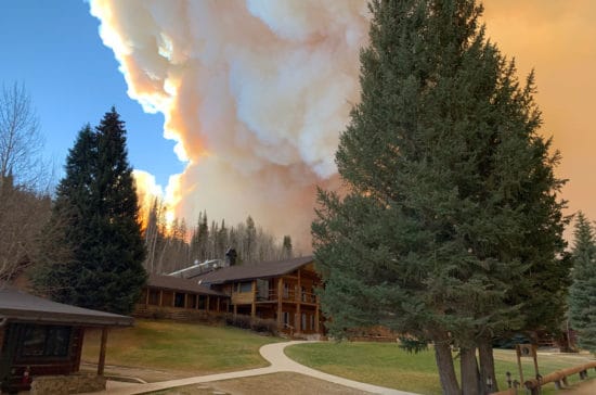 The lodge with smoke billowing in the sky