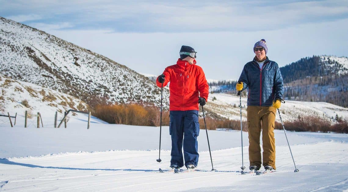 2 friends enjoy cross-country skiing at C Lazy U Ranch