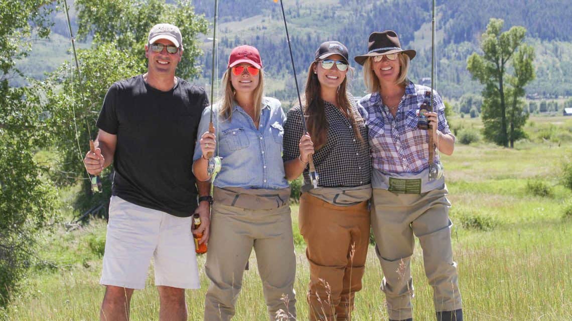 Fly fishing guests pose with their poles