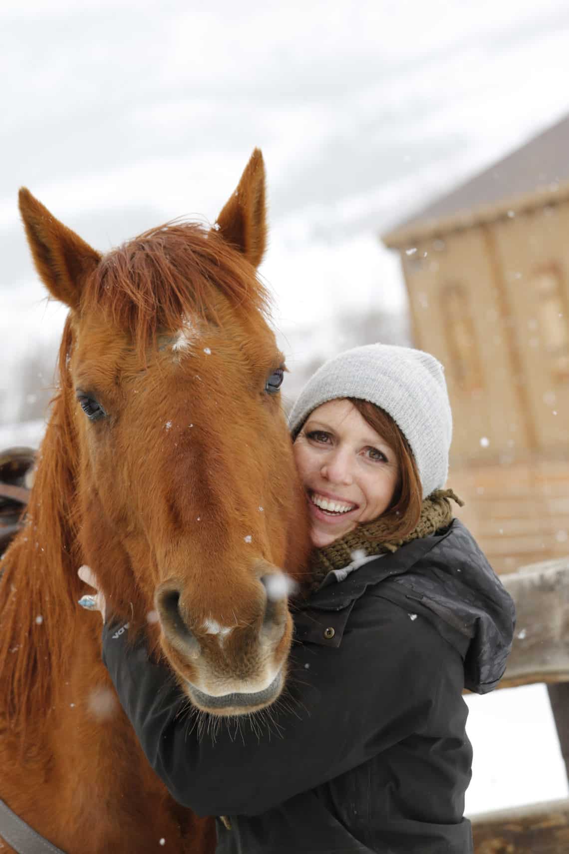 woman hugging horse