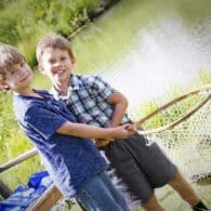 Boys have caught a fish in the pond