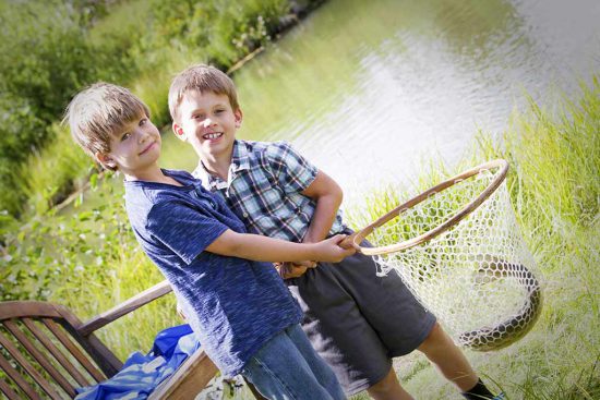 Boys have caught a fish in the pond