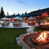 A campfire lit outside the Patio House at dusk