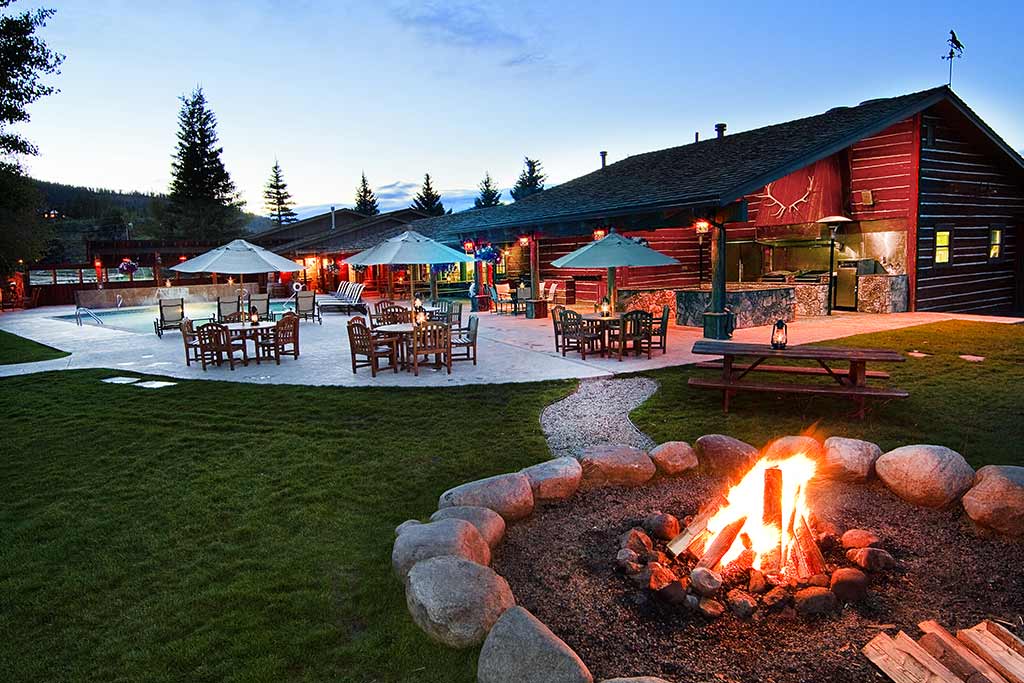 A campfire lit outside the Patio House at dusk