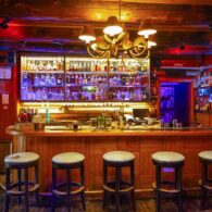 The C Lazy U Bar, showing the barstools and impressive wall of top-shelf liquors