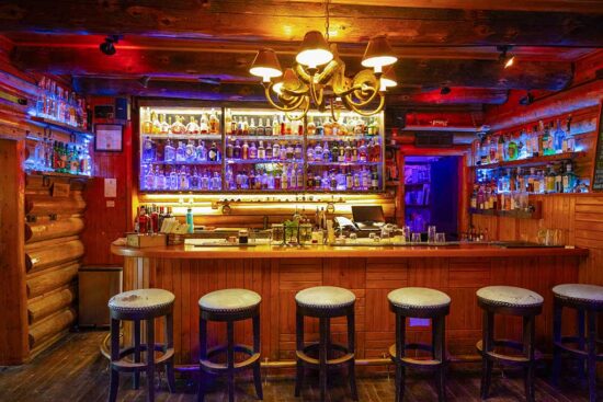 The C Lazy U Bar, showing the barstools and impressive wall of top-shelf liquors