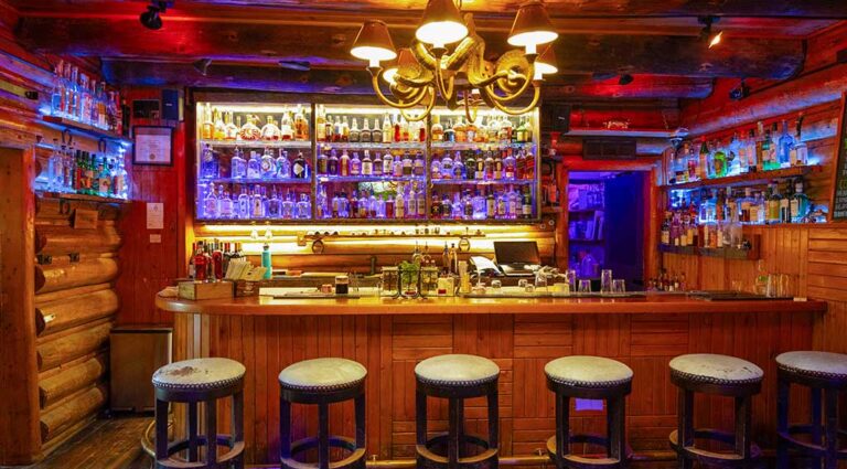 The C Lazy U Bar, showing the barstools and impressive wall of top-shelf liquors