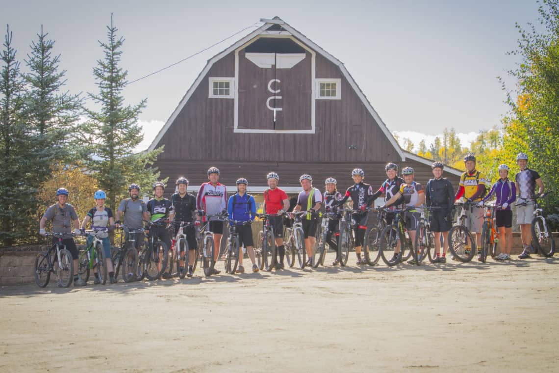 mountain bikers in front of ranch