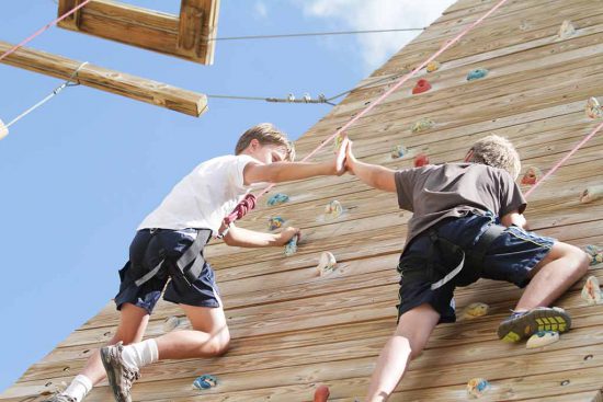 boys-high-five-on-the-climbing-wall