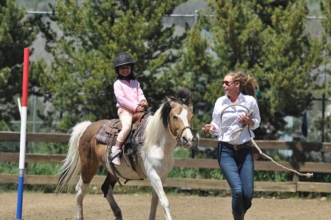Everyone participates, Colorado dude ranch style, at our weekly horseback riding pole bending event at the Shodeo.