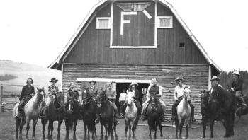 Jack Smillie, third from right, prepares to lead guests on a horseback ride. The barn was built from 1920 to 1922.