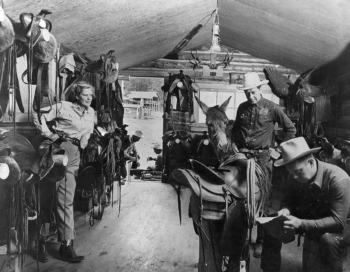 Dick and Katie Schoenberger in the tack room, being supervised by Luis, the ranch's very first donkey.