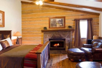 Warm up by the fireplace after a long day on your winter vacation in Colorado. Nearly all of our cabins have one.