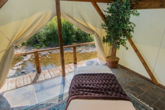 Imagine a tranquil massage by the river as a perfect way to relax on your all-inclusive ranch vacation.