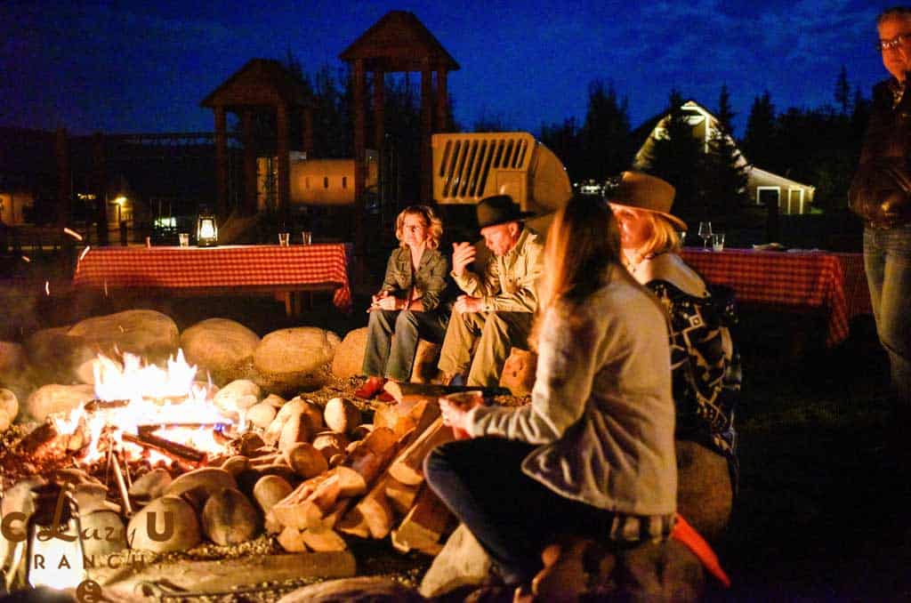 Guests gathered around a campfire at C Lazy U dude ranch