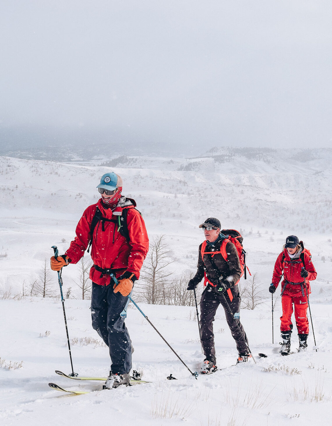 A group of men hiking uphill in the snow