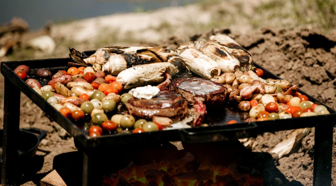 A fresh farm-to-table meal in the making over hot coals by Willow Creek