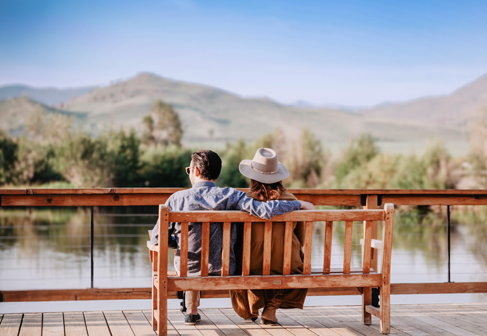 Couple sitting on bench at C Lazy U
