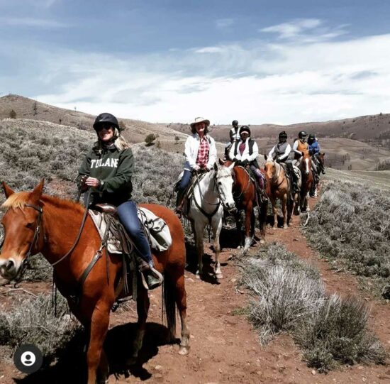 A group of women on a mountain trail enjoy summer horseback riding at all-inclusive dude ranch C Lazy U Ranch