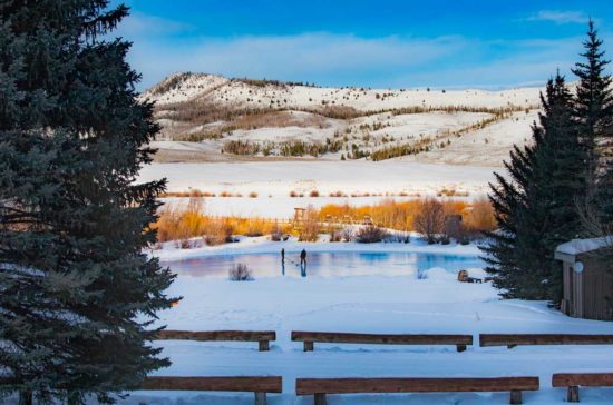 a couple plays hockey on the frozen pond