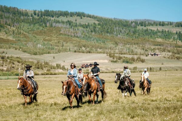 Family horseback riding at C Lazy U Ranch