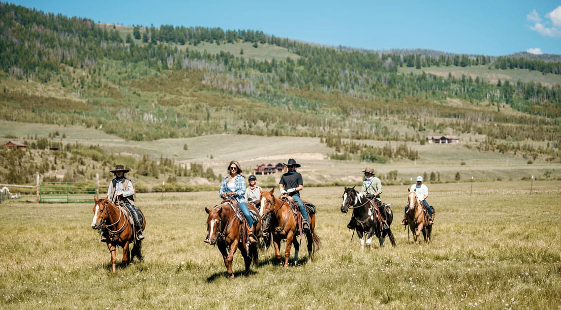 Family horseback riding at C Lazy U Ranch