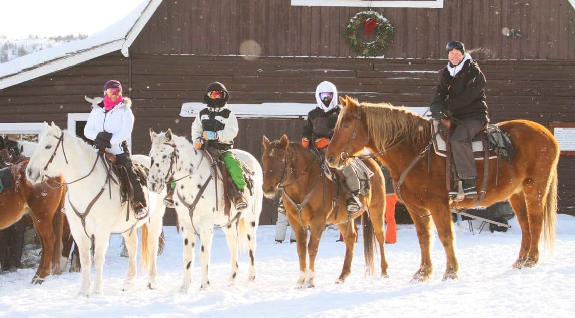 A family sets out on a horseback riding during the holidays at C Lazy U Ranch