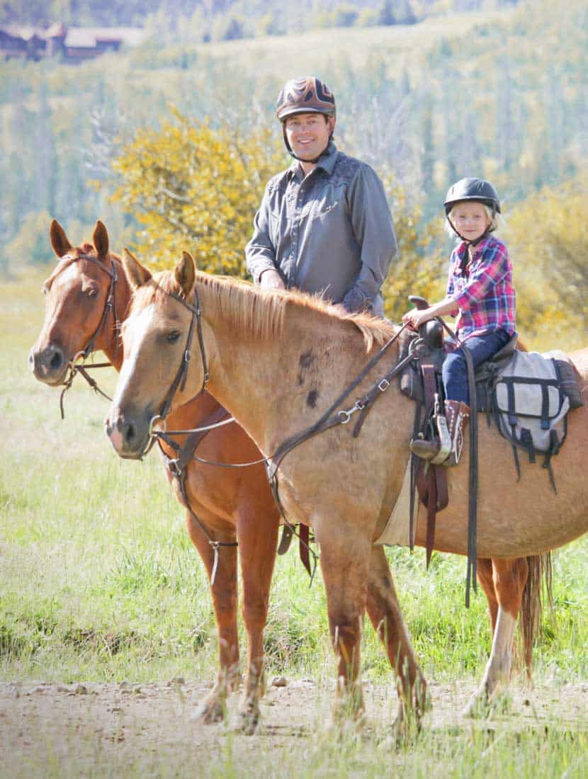 A father and daughter enjoying a trail ride