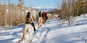 Adult riders out on the snowy trails in winter