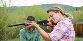 A woman trap shooting at the ranch