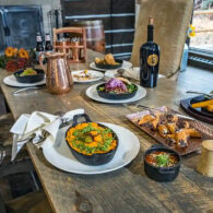 Dishes of gourmet food sit on the table, including whipped sweet potatoes