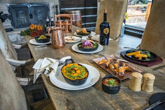 Dishes of gourmet food sit on the table, including whipped sweet potatoes