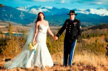 Newly married couple poses in the meadow at C Lazy U Ranch