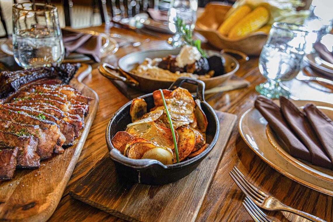 several dishes of gourmet food set out on the table ready to eat