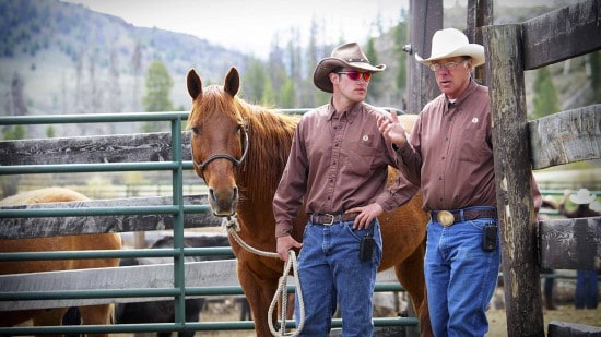 C Lazy U's head wrangler Bill discusses the horses with another wrangler