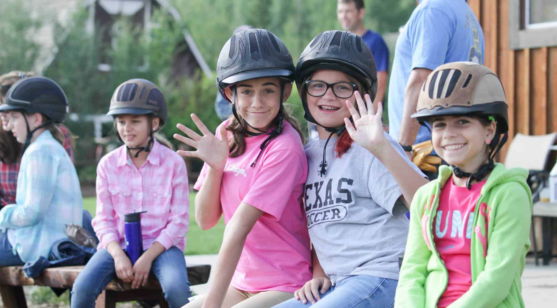 Group of kids waving to camera