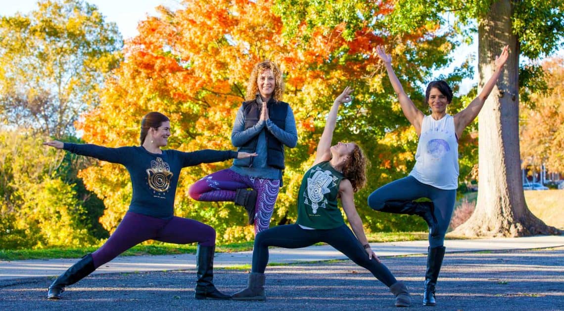 4 women doing yoga poses